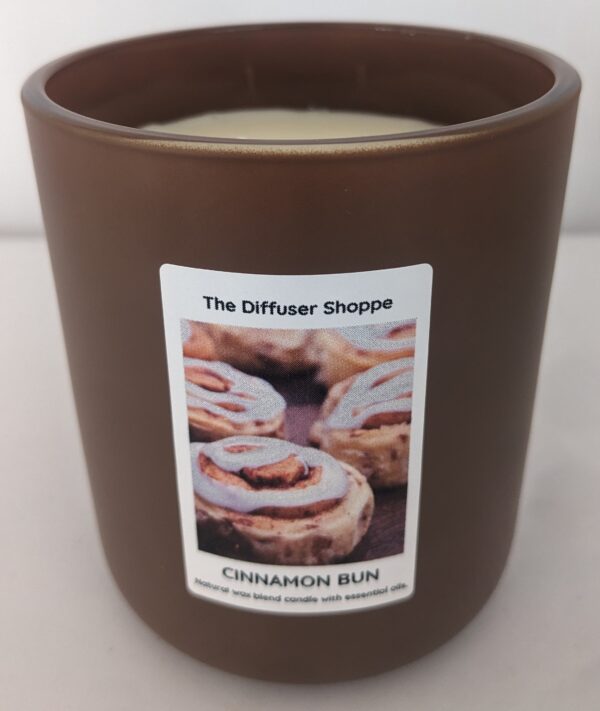 A candle that has some cinnamon rolls in it