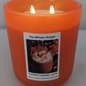A candle that has been lit with the picture of a pumpkin.