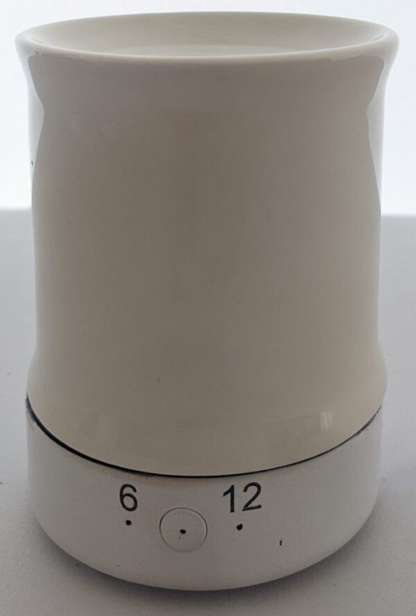 A white ceramic coffee mug with the number six and twelve on it.