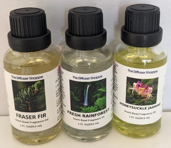 Three different oils are sitting on a table.