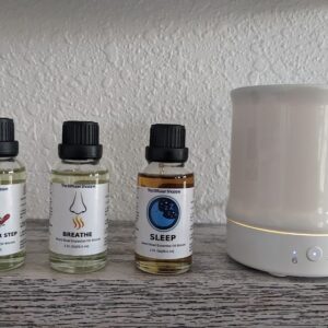 A group of bottles and an electric diffuser.