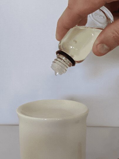 A person pouring liquid into a cup