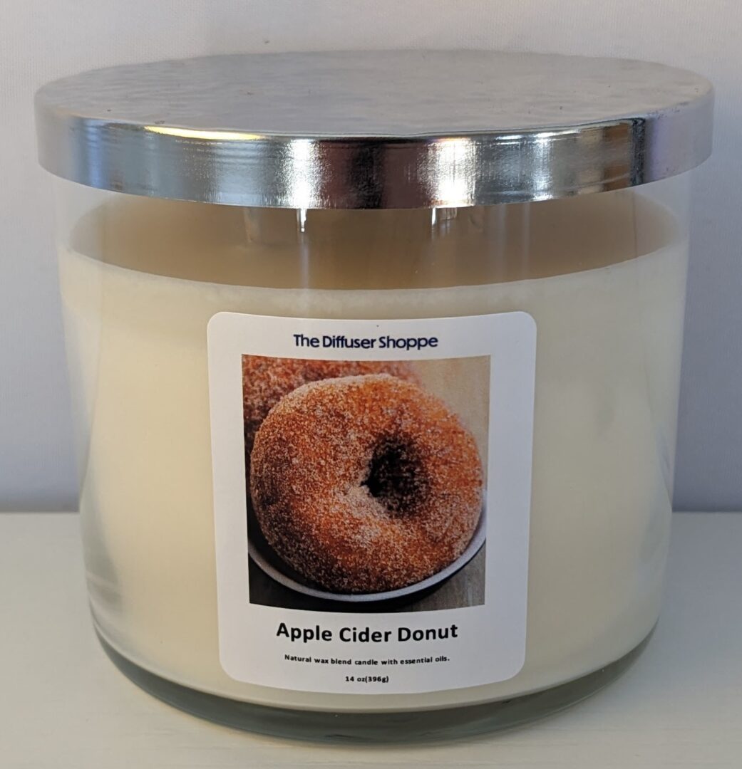 A large candle with a donut on top of it.