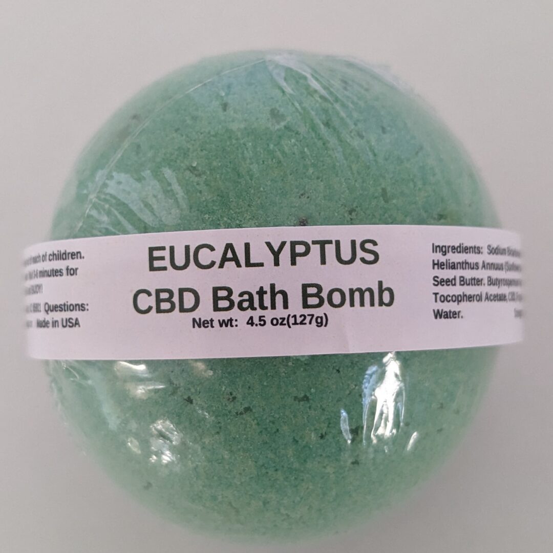 A bath bomb wrapped in white paper with the word " eucalyptus " written on it.