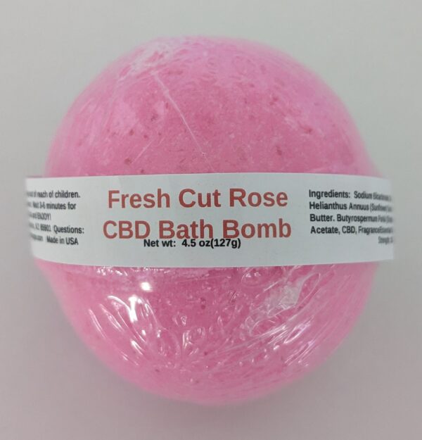 A pink bath bomb with the label fresh cut rose.