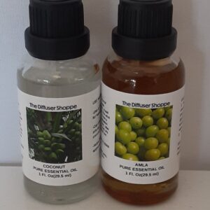 Two bottles of olive oil sitting on a table.
